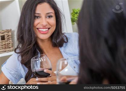 Beautiful Hispanic Latina woman with perfect teeth drinking wine at home with a female friend