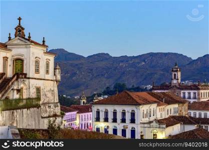 Beautiful historic city of Ouro Preto with its houses, churches, monuments and mountains. City of Ouro Preto with church and mountains