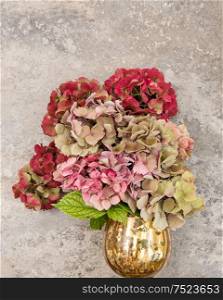Beautiful hortensia flowers bouquet over grangy stone background