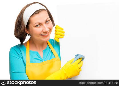 beautiful housewife holding a rag and a poster for the inscription on the white background