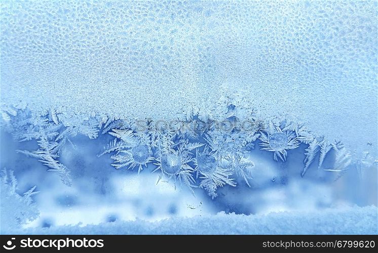 Beautiful ice pattern and frozen water drops on window glass