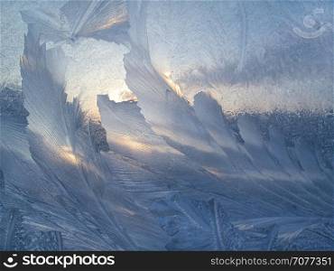 Beautiful ice pattern and sunlight on winter glass