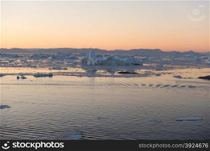 Beautiful Icebergs. Beautiful Icebergs in Disko Bay Greenland around Ilulissat with sky just after sunset
