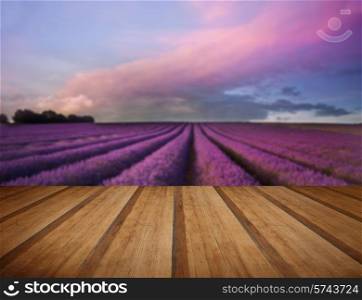 Beautiful image of lavender field Summer sunset landscape with wooden planks floor