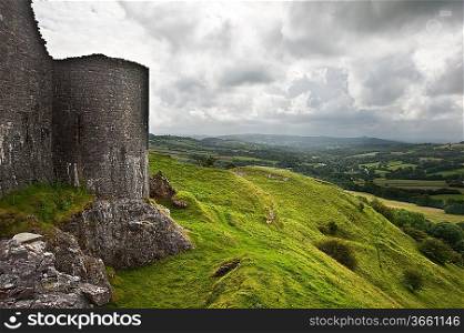 Beautiful image of medieval castle ruins in landscape with moody sky background