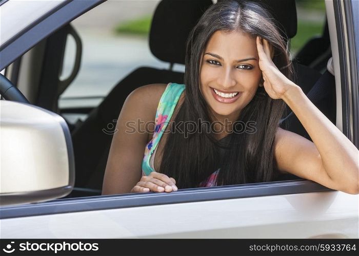 Beautiful Indian Asian young woman girl female driving a car