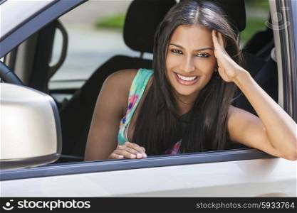 Beautiful Indian Asian young woman girl female driving a car
