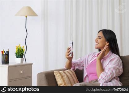 Beautiful Indian girl smiling while calling on mobile through video call