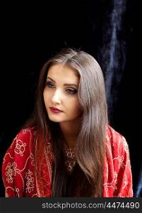 Beautiful Indian woman wearing red and gold sari