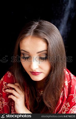 Beautiful Indian woman wearing red and gold sari