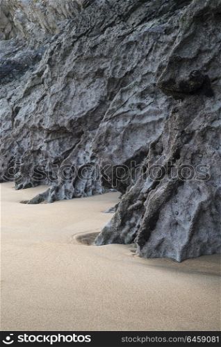 Beautiful intimate landscape image of rocks and sand on Broadhaven beach in Pembrokeshire Wales