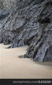 Beautiful intimate landscape image of rocks and sand on Broadhaven beach in Pembrokeshire Wales