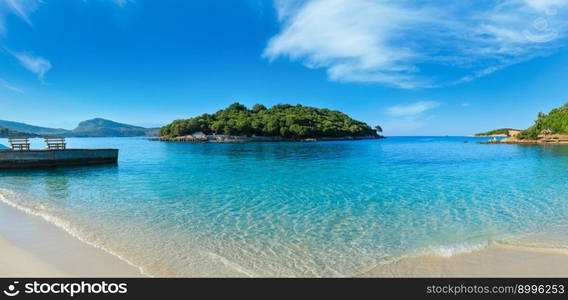 Beautiful Ionian Sea with clear turquoise water and morning summer coast. View from Ksamil beach, Albania.Three shots stitch panorama.