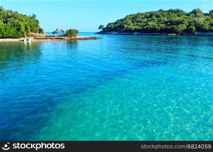 Beautiful Ionian Sea with clear turquoise water and morning summer coast view from beach (Ksamil, Albania).