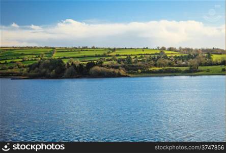 beautiful irish landscape green meadows at calm river Co.Cork, Ireland Europe