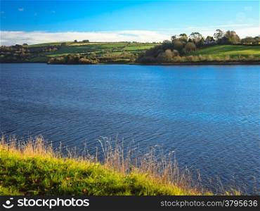 beautiful irish landscape green meadows at calm river Co.Cork, Ireland Europe