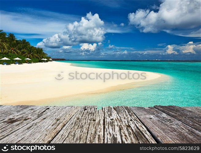 Beautiful island beach and old wooden pier at Maldives