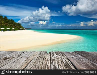 Beautiful island beach and old wooden pier at Maldives