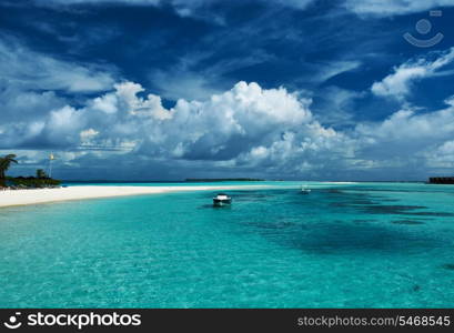 Beautiful island beach with sandspit at Maldives