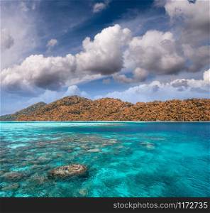 Beautiful island with clouds and crystal clear waters
