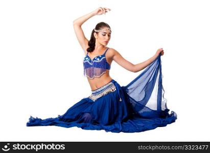 Beautiful Israeli Egyptian Lebanese Middle Eastern belly dancer performer in blue skirt and bra with arm in air sitting with eyes closed, isolated.