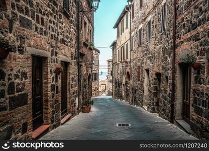 Beautiful Italian street of old town in Italy. Houses are neatly decorated with colorful plant and flowers.. Beautiful Italian street of old town in Italy.