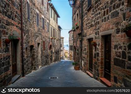 Beautiful Italian street of old town in Italy. Houses are neatly decorated with colorful plant and flowers.. Beautiful Italian street of old town in Italy.