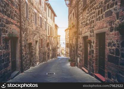 Beautiful Italian street of old town in Italy. Houses are neatly decorated with colorful plant and flowers.. Beautiful Italian street of old town in Italy.