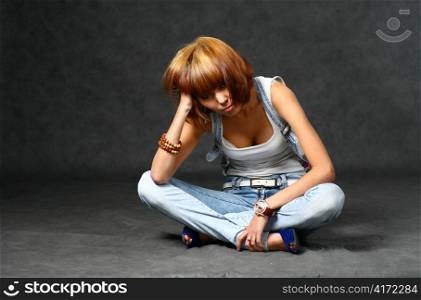 Beautiful Japanese girl in jeans over dark grey background