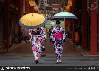 Beautiful japanese girls in kimono and with umbrella.