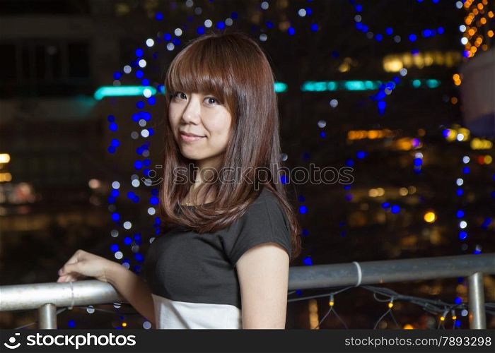 Beautiful Japanese woman in city at night