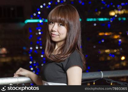 Beautiful Japanese woman in city at night