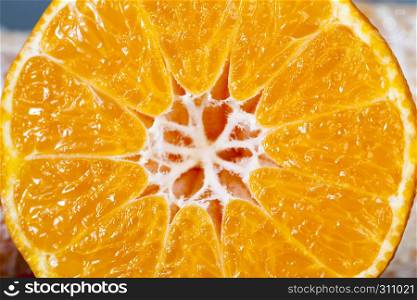 Beautiful juicy mandarin cut in half with a knife, visible structure and juice. Beautiful juicy mandarin