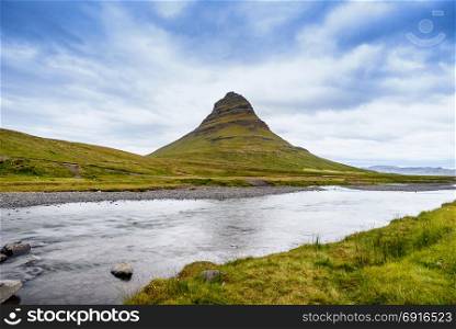 Beautiful Kirkjufell mountain with cloudy, Snaefellsnes peninsula, Iceland, selective focus