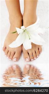 beautiful lady feet with madonna lily in spa