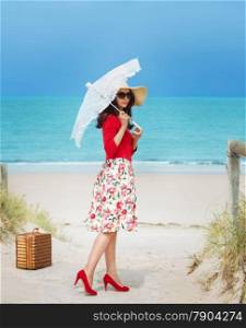 beautiful lady in red traveler in retro style dress on the beach