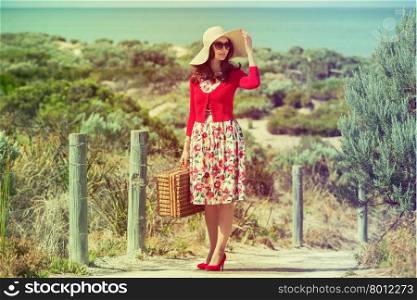 beautiful lady in red traveler on the beach in retro style