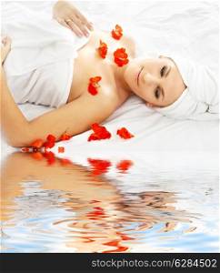 beautiful lady with red flower in spa with water
