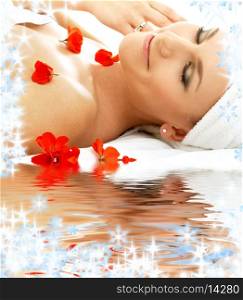 beautiful lady with red flowers in spa