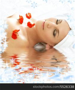 beautiful lady with red flowers in spa