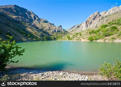 beautiful lake and summer rocks mountain behind (Zelenogorye village, Crimea, Ukraine)