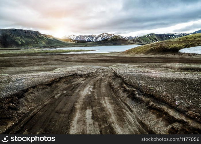 Beautiful Landmanalaugar gravel dust road way on highland of Iceland, Europe. Muddy tough terrain for extreme 4WD 4x4 vehicle. Landmanalaugar landscape is famous for nature trekking and hiking.