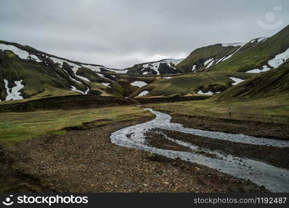 Beautiful Landmanalaugar gravel dust road way on highland of Iceland, Europe. Muddy tough terrain for extreme 4WD 4x4 vehicle. Landmanalaugar landscape is famous for nature trekking and hiking.