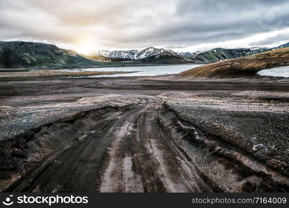 Beautiful Landmanalaugar gravel dust road way on highland of Iceland, Europe. Muddy tough terrain for extreme 4WD 4x4 vehicle. Landmanalaugar landscape is famous for nature trekking and hiking.