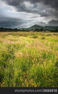 Beautiful landscape across countryside to mountains in distance with moody sky