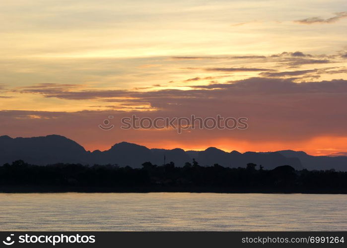 beautiful landscape, early morning on the river with silhouette mountains and tree