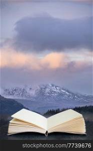 Beautiful landscape image across Loch Lomond looking towards snow capped Ben Lui mountain peak in Scottish Highlands coming out of pages in book composite image