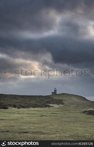 Beautiful landscape image of Belle Tout lighthouse on South Downs National Park during stormy sky