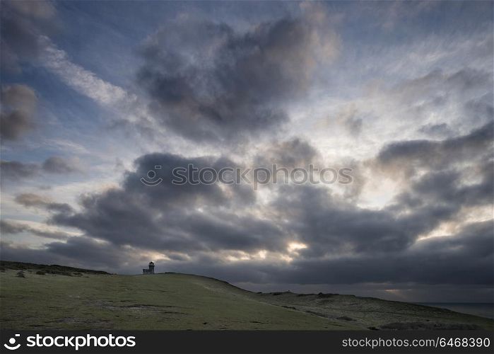 Beautiful landscape image of Belle Tout lighthouse on South Downs National Park during stormy sky