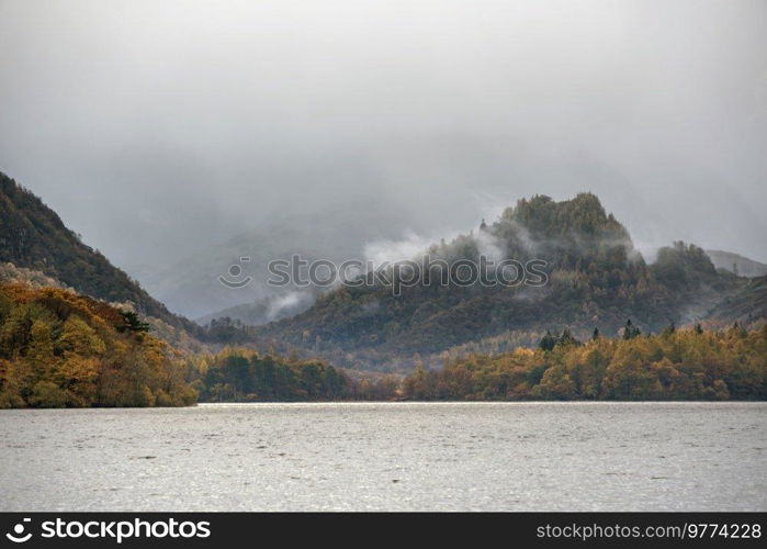 Beautiful landscape image of Caste Crag shrouded in mist during Autumn view along Derwentwater in Lake District